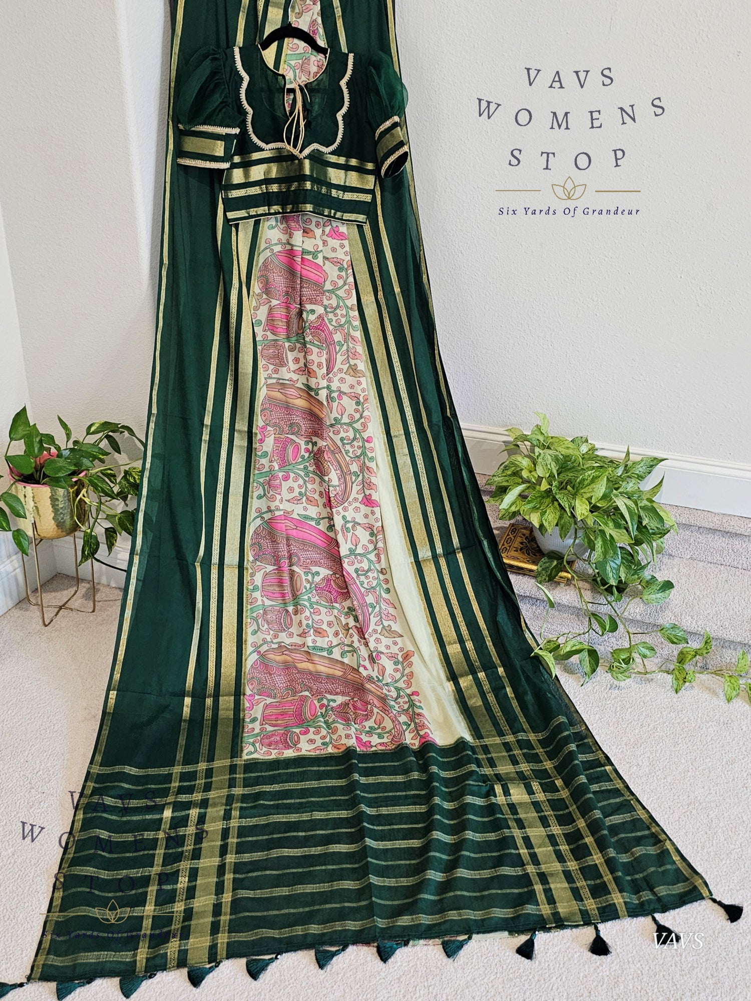 Green saree with floral patterns on a white background