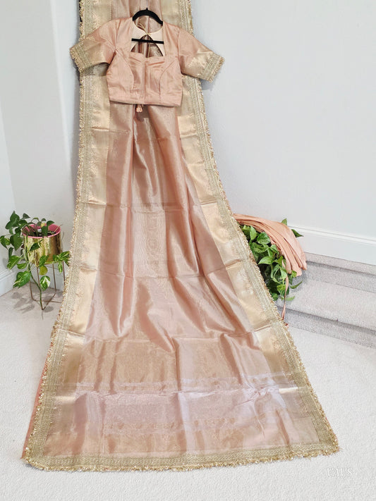 Elegant Maharani-style semi tissue saree in peach shade with stitched blouse and satin petticoat. Ready to wear with rich border detailing, perfect for weddings and festive occasions.