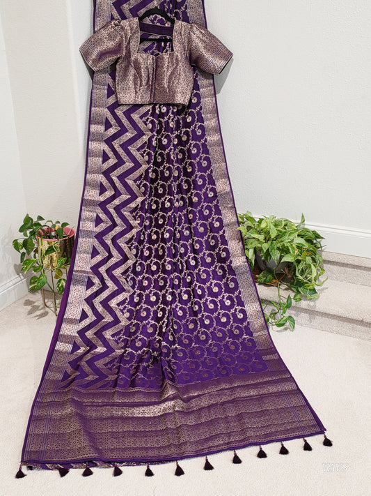 Purple semi raw mango silk saree with zari woven motifs and stitched blouse. Ready to wear with fall and pico, perfect for festive and wedding occasions.