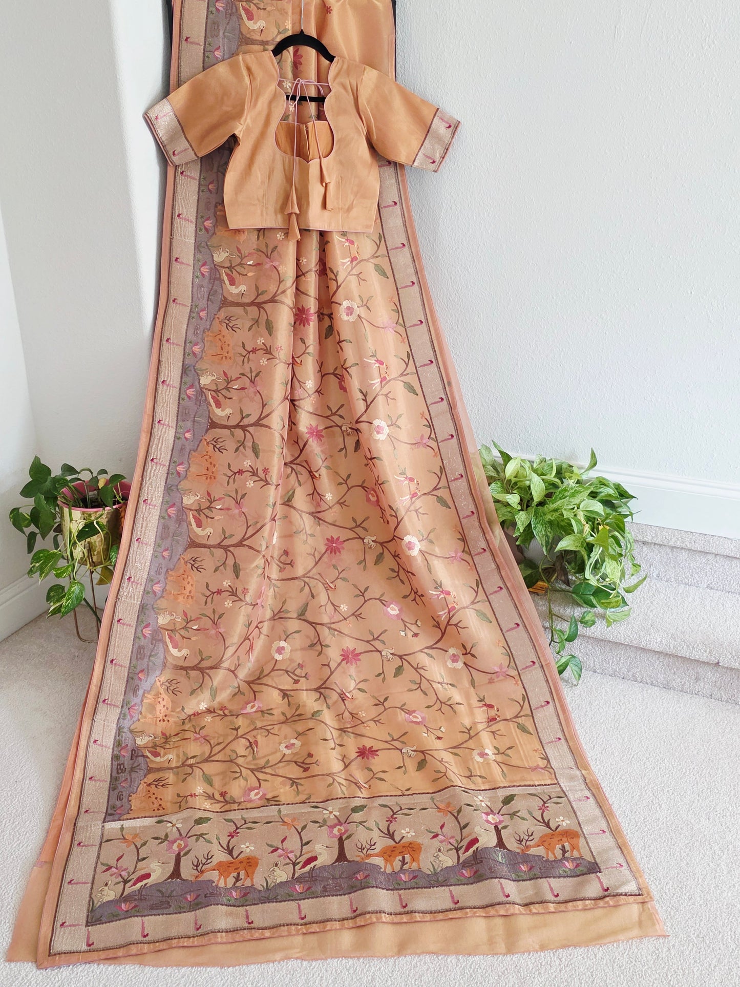 Shop soft 1g tissue saree in peach blush with whimsical forest floral embroidery. Includes stitched blouse size 36–42, front open, non padded. Fall pico done.
