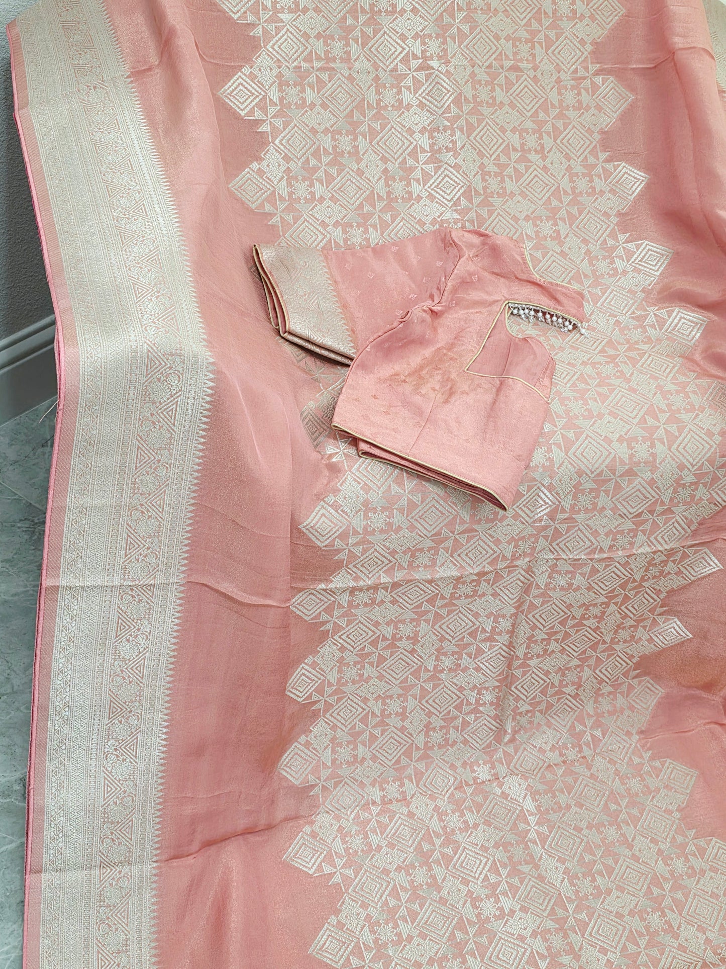 Pastel Coral Rose Soft Tissue Saree with Subtle Gold Geometry Center Design & Stitched Blouse